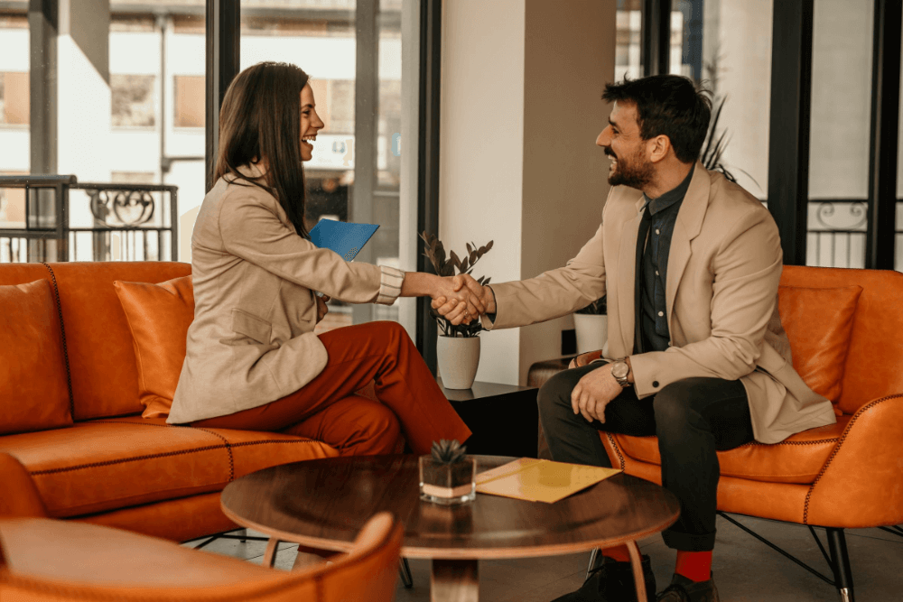 Image - Smiling woman in orange high-vis on phone