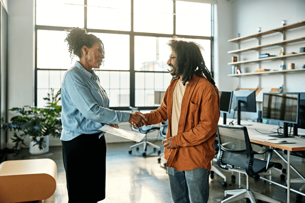 Image - Person in orange clothing writing at desk