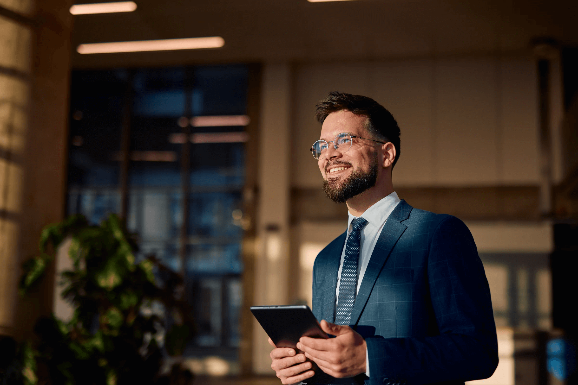 Professional reviewing documents at desk with computer